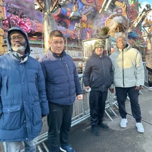 People we support and staff enjoying rides and festive activities at Winter Wonderland, Park House