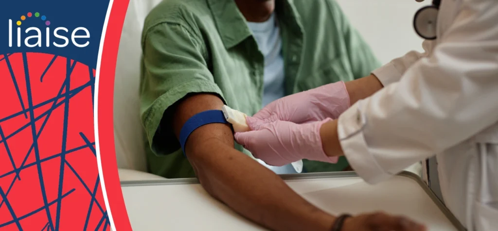 Jack supported by staff overcoming fear during a blood test, demonstrating achieving positive outcomes